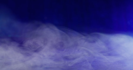 Fog cloud. Mist pigment. Defocused blue neon color smoke water acrylic ink texture floating on abstract dark black art background.の写真素材