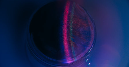 Neon spill. Gleam art. Defocused purple pink blue circle ink bright texture vibrant rainbow stripes floating on abstract fluorescent background.の写真素材