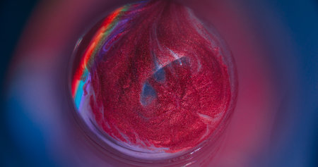 Light texture. Shiny ink. Defocused purple red green color round rainbow emulsion leaking on...