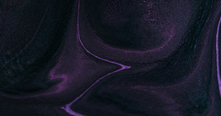 Paint splash. Chemical texture. Defocused purple color flowing pigment liquid emulsion floating on...