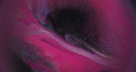 Flowing liquid. Shimmer ink. Defocused pink purple neon color splash water particles sparkling...