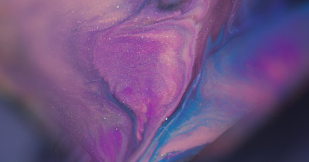 Ink stains. Ripple splash. Defocused purple blue pink color water sparkling texture floating on...