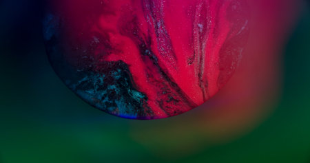 Emulsion spilling. Flowing paint. Defocused pink blue neon color glitter water floating on abstract creative bokeh light background.の写真素材