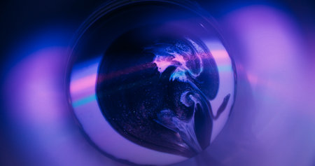 Neon paint spill. Round light. Defocused purple pink green color droplets rainbow texture floating on abstract fluorescent art background.の写真素材