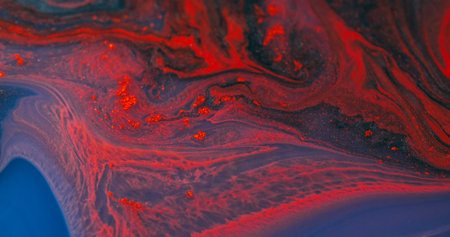 Flowing ink. Particles fluid. Defocused orange blue purple color wet shiny texture floating on...