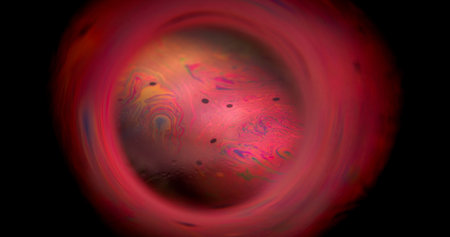 Soap blur bubble. Colorful paint planet. Round lens mix dye flow on frame black background. Night...