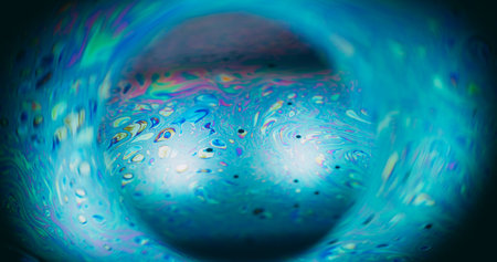 Bubble blur planet. Ink spill. Neon color fluid mix glowing sphere. Cosmic globe gasoline blue green...