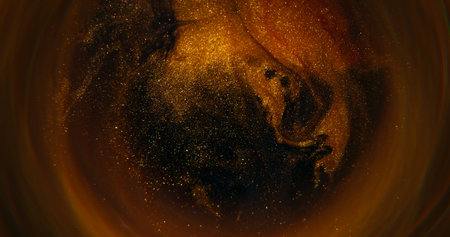 Golden paint. Blur round ink. Defocused yellow colorful glitter pigment sparkling water spilling on...