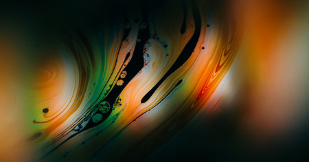Liquid flare texture. Defocused soap blend. Colorful ink light spilling in orange green emulsion....
