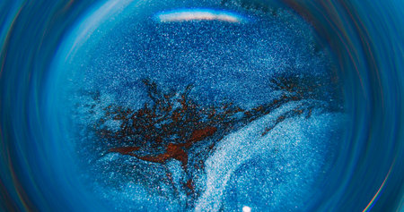 Blur ink flow. Pigment mix. Defocused blue golden color shiny round texture circling on abstract...