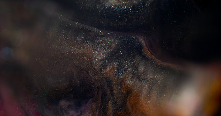 Ink color. Blur mix fluid. Defocused orange purple glitter water texture sequins liquid on abstract...