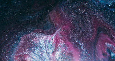 Flowing wave. Glitter fluid. Defocused pink purple silver color paint sparkling droplets spreading on abstract marble art background.の写真素材