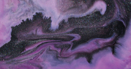 Sparkling splash. Ink liquid. Defocused purple pink color splatter glitter texture floating on...