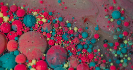 Drop flow. Color bubbles. Defocused pink blue yellow sparkling ink water oil droplets shimmer...