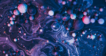 Paint bubbles. Purple oil background. Defocused blue color acrylic blend liquid round wet sphere pigment texture on art abstraction.の写真素材