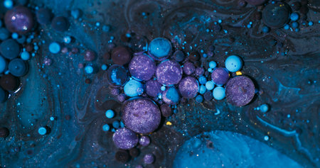 Bubbles blend. Sparkling paint. Defocused purple blue yellow color glitter oil acrylic water round fluid circle on abstract background.の写真素材