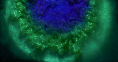 Shimmering dust. Paint explosion. Blue violet green shiny powder swirl spill on black background....