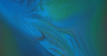 Blur marble background. Spilling fluid. Defocused blue green color ink chemical sparkling pigment floating on acrylic abstraction.の写真素材