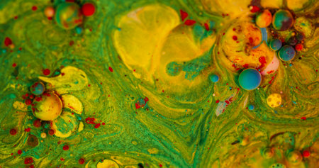 Bubbles stream. Oil drop. Defocused green yellow blue colorful paint fluid round mix water emulsion floating on abstract art background.の写真素材