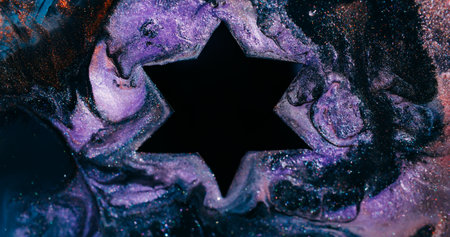 Paint drip. Acrylic star. Blur purple blue orange color water geometric fluid glitter bubble dark black particle on abstract bokeh background.の写真素材