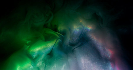 Paint blend. Color cloud texture. Defocused blue green purple splash rainbow vapor glitter water spreading on abstract dark black background.の写真素材