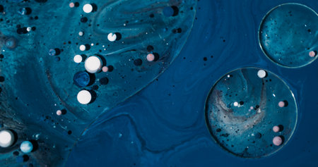 Oil texture. Ink art. Defocused blue purple white color sparkling bubbles glitter round acrylic liquid pigment floating on abstract background.の写真素材
