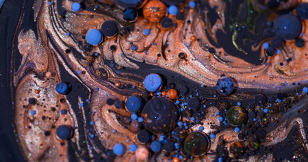 Color oil mix. Bubble art. Defocused blue orange purple ink glitter droplet round texture acrylic pigment circle on abstract background.の写真素材