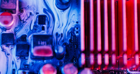 Ink flow. Digital hardware. Defocused blue red pink colorful glitter water electronic motherboard microchip on abstract art neon background.の写真素材