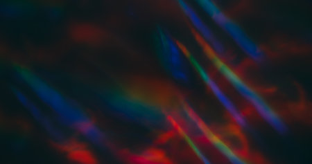 Defocused light lens. Holographic flare. Red green blue neon colorful luminosity on dark black...