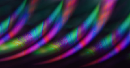 Blur flow bubble. Ink liquid. Green yellow purple color oil chemical curve texture floating on abstract dark black acrylic neon art background.の写真素材