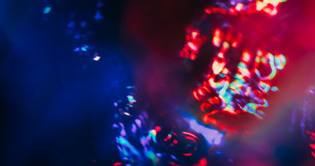 Defocused light lens. Reflection flash texture. Red blue purple bright color flare on black...