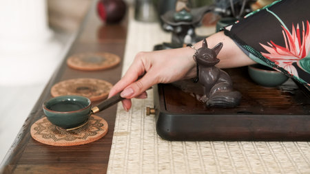 Chinese traditional drink. Tea ritual. Female hand preparing ceremony enjoying meditation aromatherapy vapor spiritual enlightenment.の写真素材