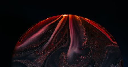 Ink defocused spread. Curve glow. Black red orange pigment spill on blur round frame. Colorful abstract leak swirl dark background.の写真素材