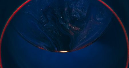 Blur paint swirl. Glowing ring. Black blue dye mixing abstract red round lens color. Pigment...