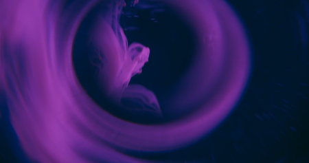 Ink wave defocused. Lens fluid. Purple liquid round swirl on black background. Art smoke splash twist abstract color circle in night.の写真素材