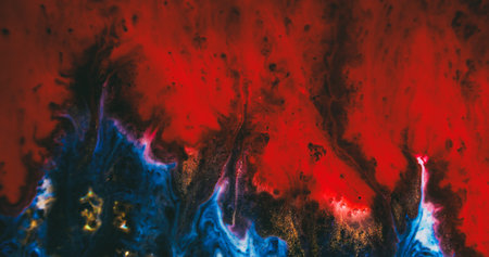 Paint flow. Defocused art texture. Red wave spill on black blue acrylic fluid. Golden glitter pigment color mix on abstract background.の写真素材