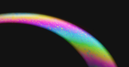 Neon arch blur. Iridescent rainbow. Colorful paint mix in curve glow on dark black background. Spectrum soap liquid abstract free space.の写真素材