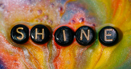 Shine word. Paint drip. Defocused yellow blue orange color glitter water letters blend glow fluid...