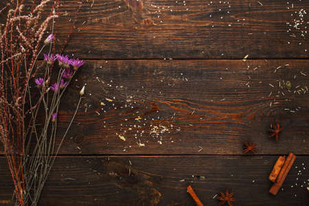 Wooden table with dry herbs flat lay free space. Top view on old rustic background with herbarium and spices, copy space for text. Craft, alternative medicine, magic conceptの写真素材