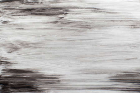 Black smears of nail polish background. Stains of dark paint on white background. Ground, night, beauty, makeup,abstract art, decorative cosmetics conceptの写真素材