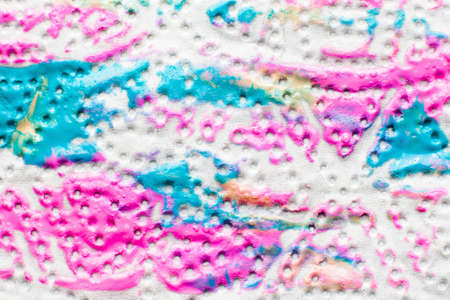 Colorful paint print on textured fabric closeup. Polka-dot pattern with pink and blue nail polish imprint, free space. Art, creative, design, decorative cosmetics, beauty conceptの写真素材