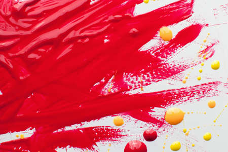 Nail polish bright texture free space. Smears of bloody varnish with yellow and pink drops on white background. Cosmetic, makeup, beauty, fashion conceptの写真素材