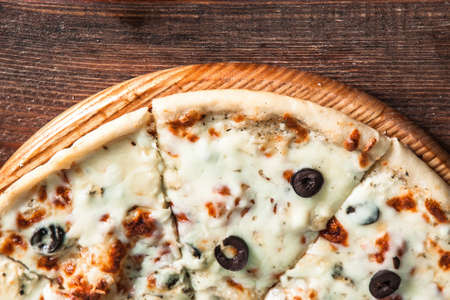 Traditional Italian food. Fresh yummy pizza on wooden rustic table with copy space for text, top view. Horizontal photo.の写真素材