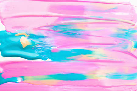 Mix of pink, blue and yellow nail polish. Bright colorful background of paint stains, free space....