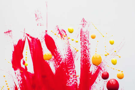 Smears of red polish with yellow drops free space. Bloody nail varnish stains on white background, bright cosmetic backdrop. Glamour, fashion, makeup, beauty conceptの写真素材