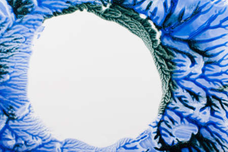 Mysterious stains of blue paint free space. Cold colors of nail polish frame on white background. Winter, abstract art, creative, decorative cosmetic, beauty conceptの写真素材