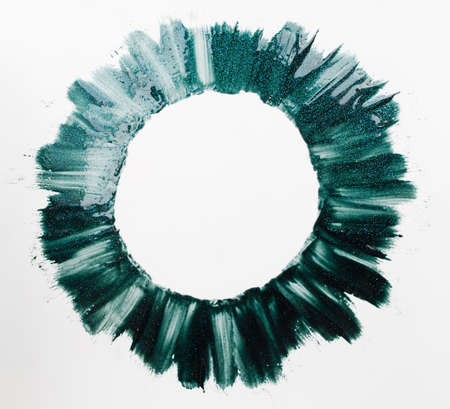 Round frame of green nail polish paints free space. Virid circle of varnish on white background. Forest, summer, nature, abstract art, beauty conceptの写真素材