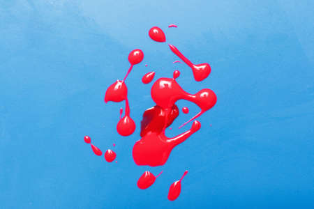 Blood swab sample, laboratory analysis, microbiology test. Creative modern art, red paint drops on blue background.の写真素材