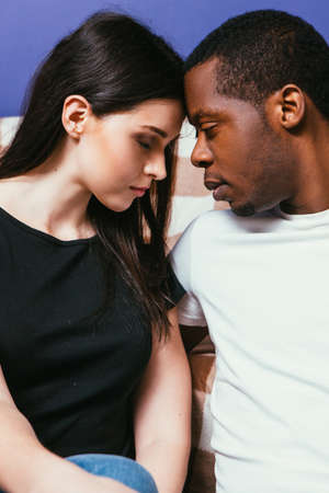 Young couple together, black man and white woman closeup. International relationship, calmness, togetherness, rest concept.の写真素材
