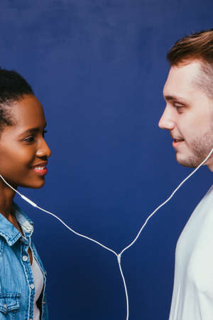 Couple Interracial Music Listen Earphones Enjoy Smile Togetherness Love Equality Happiness Unity Connection Relationship Conceptの写真素材